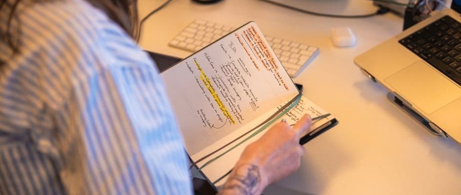Reviewing handwritten brand strategy notes at a desk