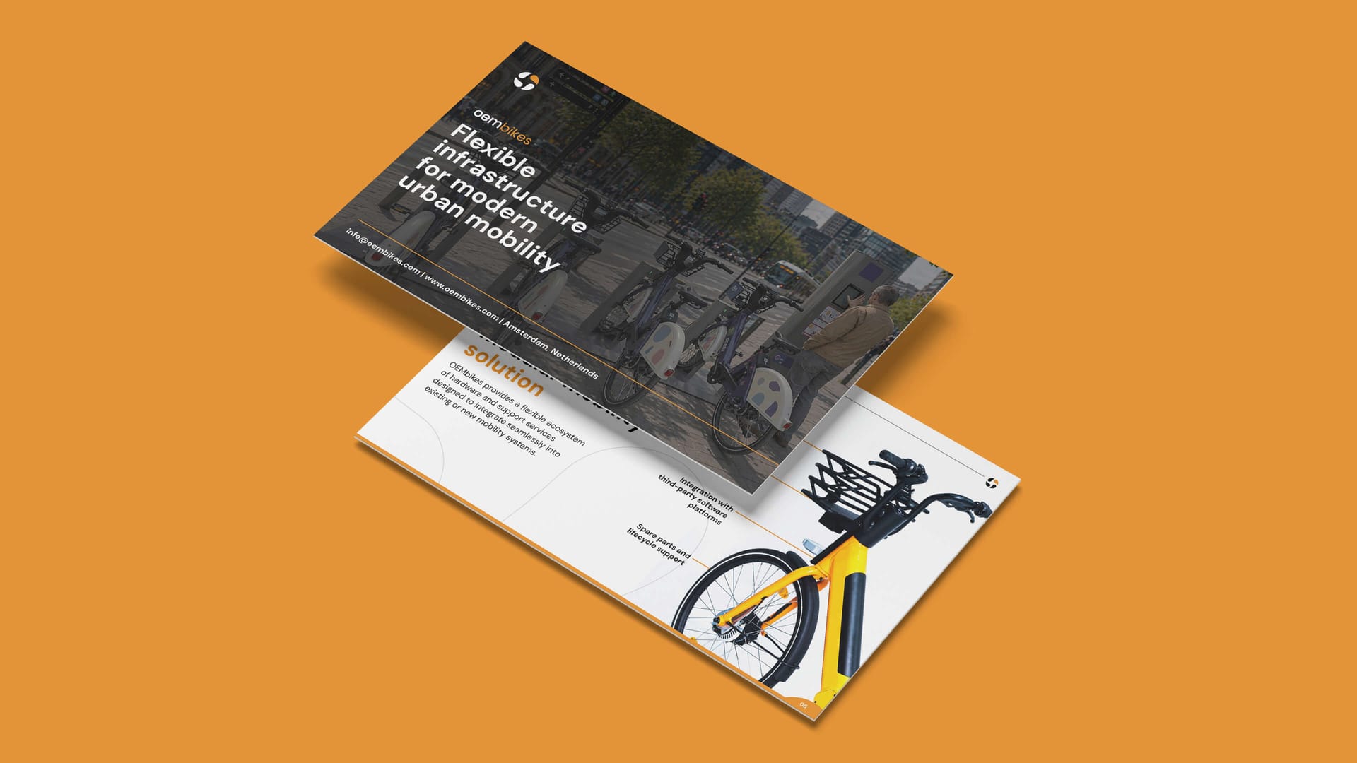 OEMbikes flyer card mockup showing Flexible Infrastructure for Modern Urban Mobility cover on orange background, print design by On Poynt Creative