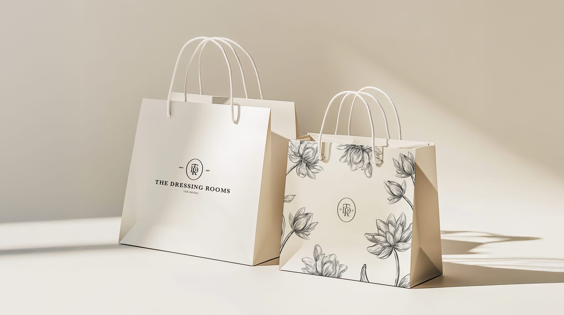 The Dressing Room Bridal branded paper shopping bags with floral pattern design, packaging design by On Poynt Creative